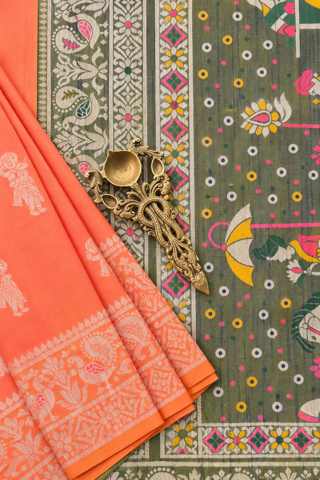 Anvika semi raw silk saree with coral peach and olive tones and resham weaving by Tattva Crafted Elegance