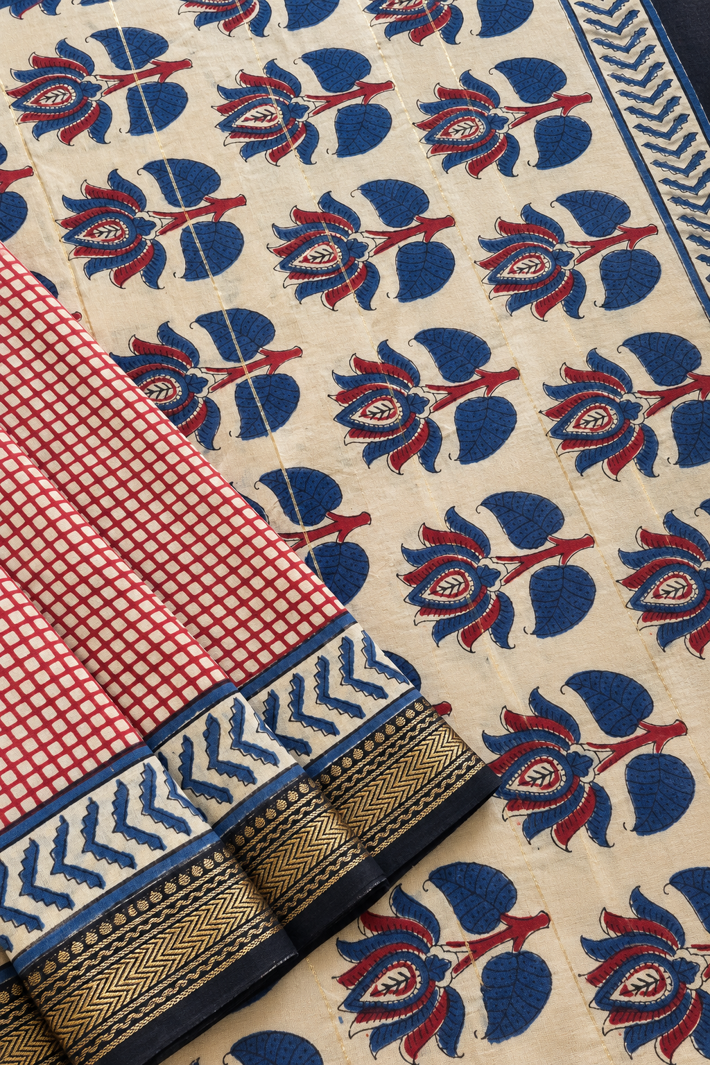 Gargi hand block printed silk cotton saree featuring a red and beige checkered body, contrasting floral pallu and golden zari border by Tattva Crafted Elegance.