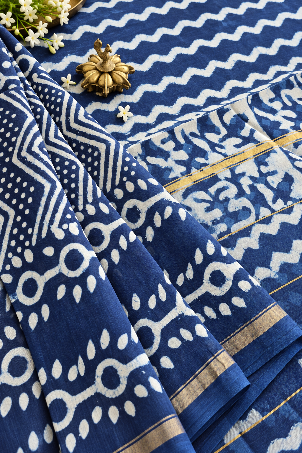 Tara indigo silk cotton saree with geometric block print motifs, zigzag patterns and golden zari border by Tattva Crafted Elegance.