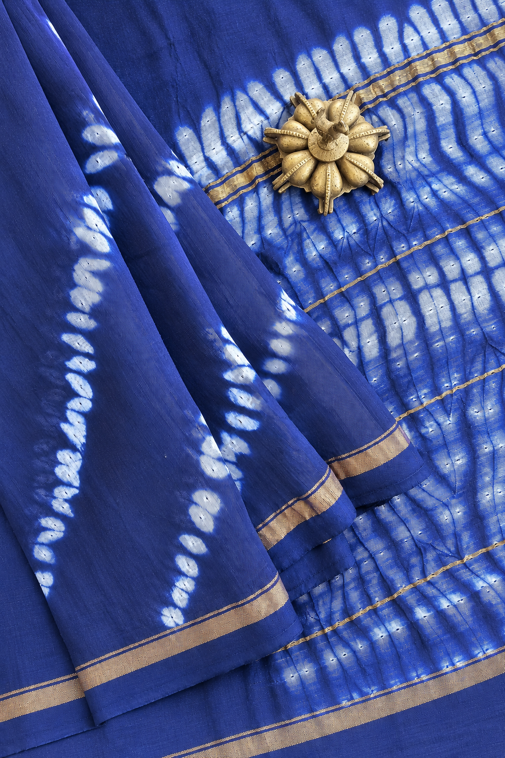 Neelika indigo Shibori Lehariya Chanderi silk cotton saree with golden zari border by Tattva Crafted Elegance.