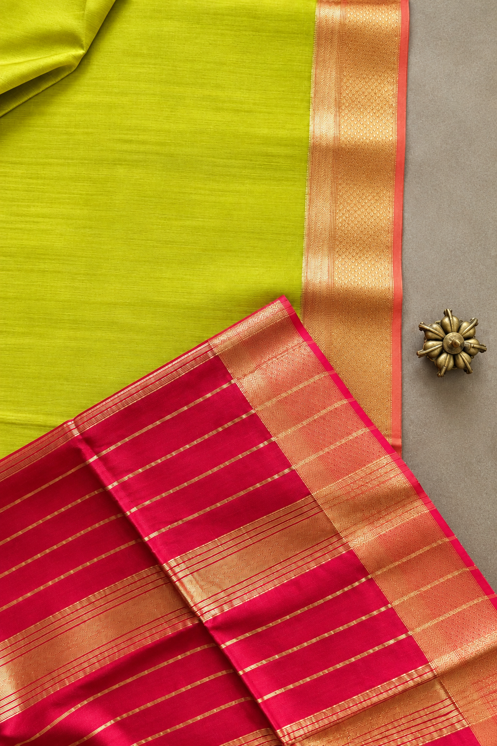 Lehar Maheshwari silk cotton saree featuring lime green body, contrasting red striped pallu and intricate gold zari weaving.