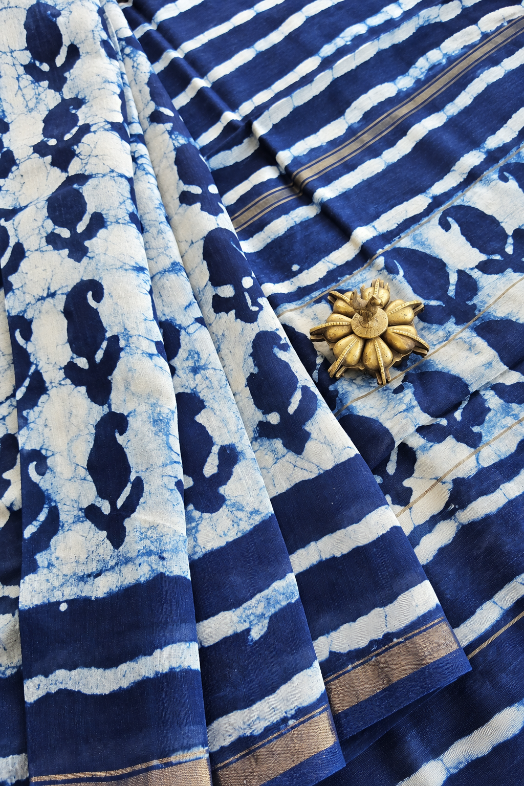 Mihika indigo hand block printed silk cotton saree featuring traditional paisley motifs, striped patterns and golden zari border by Tattva Crafted Elegance.