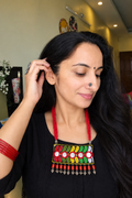 Woman wearing multicoloured Kutchi fabric necklace with mirror work