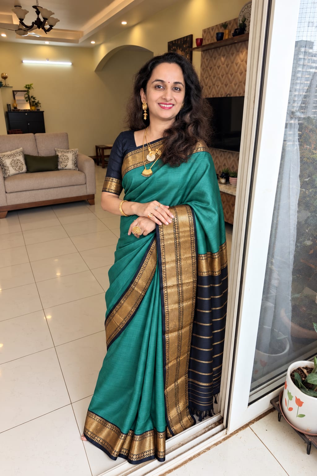 Tarang sea green Maheshwari handloom silk cotton saree with black pallu and gold zari border.