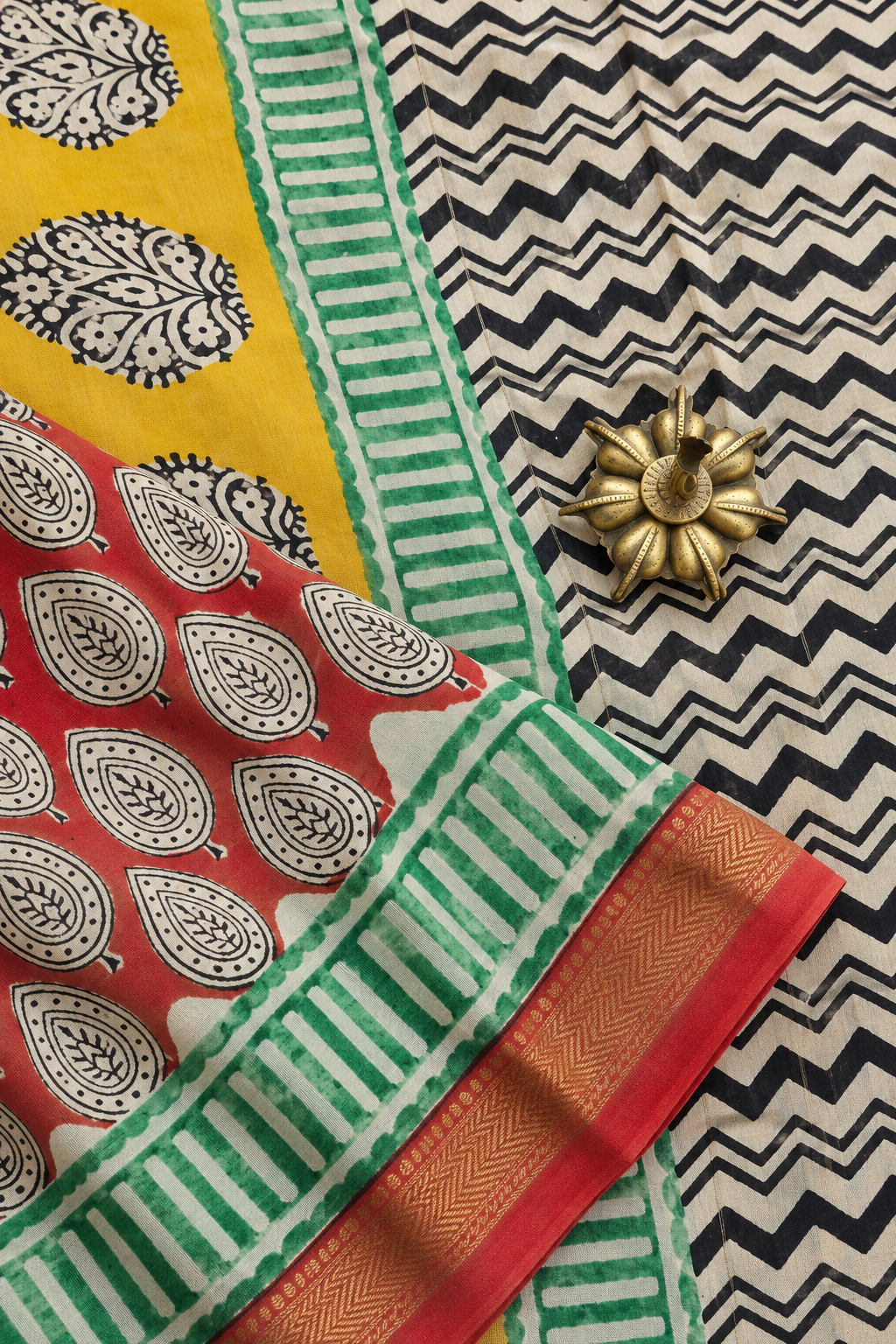 Vrinda red hand block printed silk cotton saree with small leaf motifs, contrasting yellow floral pallu and golden zari border by Tattva Crafted Elegance.