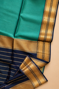 Tarang Maheshwari silk cotton saree in sea green with traditional black and gold zari detailing.
